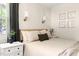 Bedroom featuring floral art, bedside tables, and soft, neutral tones at 2702 Richwood Rd, Durham, NC 27705