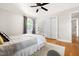 Bright bedroom with hardwood floors, a ceiling fan and a closet with sliding doors at 2702 Richwood Rd, Durham, NC 27705