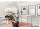 Close up of dining table with plant and artwork in a naturally lit, open floor plan at 2702 Richwood Rd, Durham, NC 27705