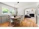 Charming dining area with hardwood floors, wainscoting and views to the living room, showcasing an open floorplan at 2702 Richwood Rd, Durham, NC 27705