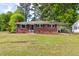 Charming single-story brick home featuring a well-maintained lawn and attached carport at 2702 Richwood Rd, Durham, NC 27705