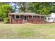 Attractive brick ranch home with landscaped lawn and a convenient side carport at 2702 Richwood Rd, Durham, NC 27705