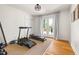 Home gym featuring workout equipment and a view of the backyard from the deck at 2702 Richwood Rd, Durham, NC 27705