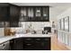 A view from the kitchen that shows stainless steel appliances, dark cabinets and the nearby dining room at 2702 Richwood Rd, Durham, NC 27705