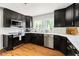 Modern kitchen featuring stainless steel appliances, dark cabinets, white countertops, and subway tile backsplash at 2702 Richwood Rd, Durham, NC 27705