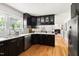 Spacious kitchen with stainless steel appliances and dark cabinets, offering an open view into the dining room at 2702 Richwood Rd, Durham, NC 27705