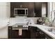 Modern kitchen featuring stainless steel appliances, white countertops, and dark cabinetry at 2702 Richwood Rd, Durham, NC 27705