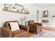 A living room showcases modern brown leather seating, artwork, and a cushioned bench at 2702 Richwood Rd, Durham, NC 27705