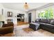 Open-concept view of the living room showcasing the entryway, seating area, and kitchen at 2702 Richwood Rd, Durham, NC 27705
