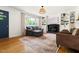 Inviting living room with a black fireplace, built-in shelves, and a comfortable gray sofa at 2702 Richwood Rd, Durham, NC 27705