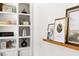 Stylish built-in shelving with decorative items and a wooden shelf with framed pictures at 2702 Richwood Rd, Durham, NC 27705