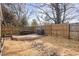 Fenced backyard featuring a wood deck with an outdoor dining set and barbecue at 2728 Cherry Field Dr, Raleigh, NC 27603