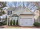 Charming home featuring a brick driveway, cream siding, a bay window and attached garage at 2728 Cherry Field Dr, Raleigh, NC 27603