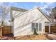 A view of the home's exterior with a lawn, fence, and large windows at 2728 Cherry Field Dr, Raleigh, NC 27603