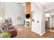 Open living space with brick fireplace, hardwood floors, and barstool seating at 2728 Cherry Field Dr, Raleigh, NC 27603