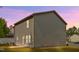 Two-story home featuring vinyl siding and a grassy yard, set against a backdrop of a dusky sky at 2800 Elsa Dr, Raleigh, NC 27610