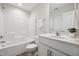 Bathroom featuring a shower-tub combo, white cabinetry, and marbled countertops, for a sleek, modern look at 2800 Elsa Dr, Raleigh, NC 27610