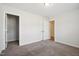 Bedroom with neutral-colored walls and plush gray carpeting, with access to additional rooms at 2800 Elsa Dr, Raleigh, NC 27610