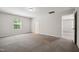 Spacious carpeted bedroom with neutral walls, a large window, and access to a private bathroom at 2800 Elsa Dr, Raleigh, NC 27610