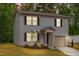 Two-story home with gray siding, black shutters, manicured lawn, illuminated by dusk at 2800 Elsa Dr, Raleigh, NC 27610