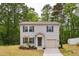 Two-story home with gray siding, black shutters, landscaped lawn and an attached garage at 2800 Elsa Dr, Raleigh, NC 27610