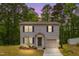 Two-story home with gray siding, black shutters, landscaped lawn and an attached garage, illuminated by dusk at 2800 Elsa Dr, Raleigh, NC 27610