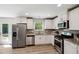 Modern kitchen featuring stainless steel appliances, white cabinets, and granite counters at 2800 Elsa Dr, Raleigh, NC 27610