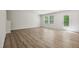 Bright open floor plan showcasing the living room with luxury vinyl plank flooring and a glass panel back door at 2800 Elsa Dr, Raleigh, NC 27610