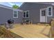 This back deck features a grill, seating, and an exterior door, creating an ideal space for outdoor enjoyment at 2811 Van Dyke Ave, Raleigh, NC 27607