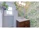 This bathroom boasts stylish wallpaper, updated fixtures, and bright lighting at 2811 Van Dyke Ave, Raleigh, NC 27607