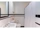 Clean bathroom featuring white tiles with black trim and classic fixtures at 2811 Van Dyke Ave, Raleigh, NC 27607