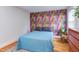 The spacious bedroom has hardwood floors and a vibrant, colorful accent wall at 2811 Van Dyke Ave, Raleigh, NC 27607