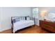Bright bedroom features hardwood floors, comfortable seating, and ample natural light at 2811 Van Dyke Ave, Raleigh, NC 27607