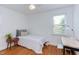 Bright bedroom with hardwood floors, ceiling fan, and natural light from the window at 2811 Van Dyke Ave, Raleigh, NC 27607
