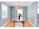 Bright dining room features hardwood floors, classic trim, and an elegant light fixture at 2811 Van Dyke Ave, Raleigh, NC 27607