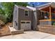 Exterior view of a gray brick home featuring a garage and an adjacent raised deck at 2811 Van Dyke Ave, Raleigh, NC 27607
