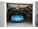 View of a well-organized garage with a stylish blue car parked inside, offering secure and convenient parking at 2811 Van Dyke Ave, Raleigh, NC 27607