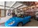 The garage is well lit and organized, featuring ample storage space and a sleek blue car parked inside at 2811 Van Dyke Ave, Raleigh, NC 27607