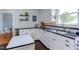 This kitchen boasts white cabinets, black countertops, and modern stainless steel appliances at 2811 Van Dyke Ave, Raleigh, NC 27607