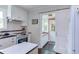 Modern kitchen features white cabinets, black countertops, a sliding barn door, and lots of natural light at 2811 Van Dyke Ave, Raleigh, NC 27607
