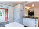 Modern kitchen features white cabinets, black countertops, and a view of the laundry room at 2811 Van Dyke Ave, Raleigh, NC 27607
