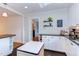 Updated kitchen with white cabinets, black countertops, open shelving, and stainless steel appliances at 2811 Van Dyke Ave, Raleigh, NC 27607