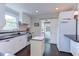 Updated kitchen features white cabinets, black countertops, stainless steel appliances, and stylish fixtures at 2811 Van Dyke Ave, Raleigh, NC 27607