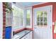 Sunlit laundry room with a sink, storage, and exterior access to the backyard at 2811 Van Dyke Ave, Raleigh, NC 27607