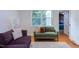 This cozy living room is light-filled and boasts large windows and warm hardwood floors at 2811 Van Dyke Ave, Raleigh, NC 27607