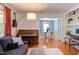 Inviting living room showcasing a modern sofa, piano, workspace, and dining area at 2811 Van Dyke Ave, Raleigh, NC 27607