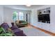 Bright living room boasts large window, hardwood floors, and custom built-in shelving, creating a stylish space at 2811 Van Dyke Ave, Raleigh, NC 27607