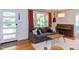 Bright living room with large windows, modern sofa, piano, and stylish decor at 2811 Van Dyke Ave, Raleigh, NC 27607