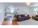 Cozy living room showcasing hardwood floors, neutral tones, with a seamless view into the updated kitchen at 2811 Van Dyke Ave, Raleigh, NC 27607