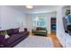 Cozy living room is light-filled, features hardwood floors, and a built-in media center at 2811 Van Dyke Ave, Raleigh, NC 27607